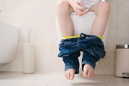 Young Child sitting on a toilet